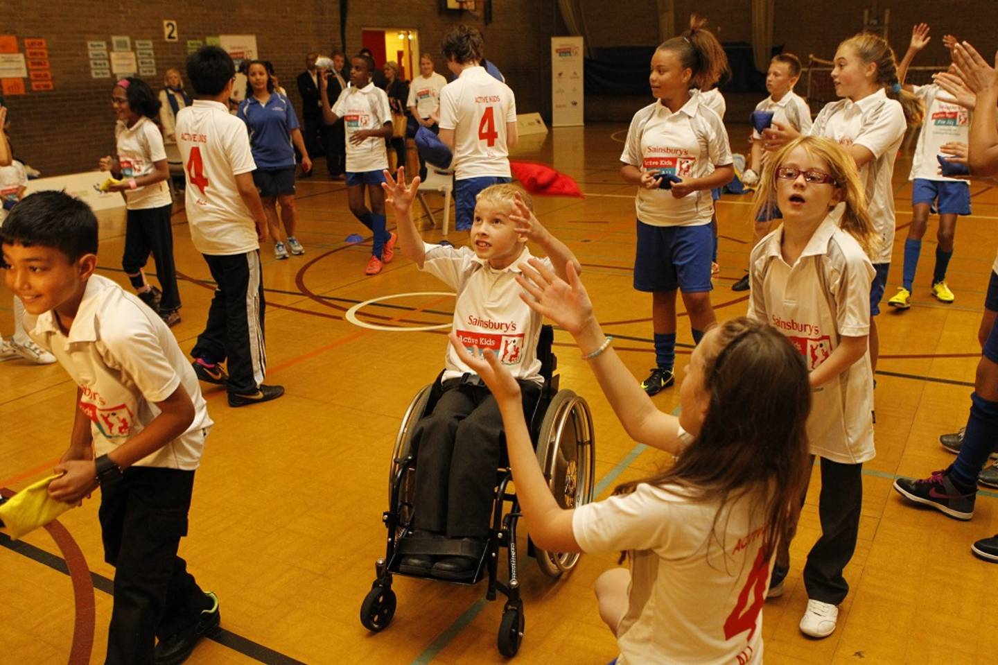 Boy in a wheelchair enjoying a PE session