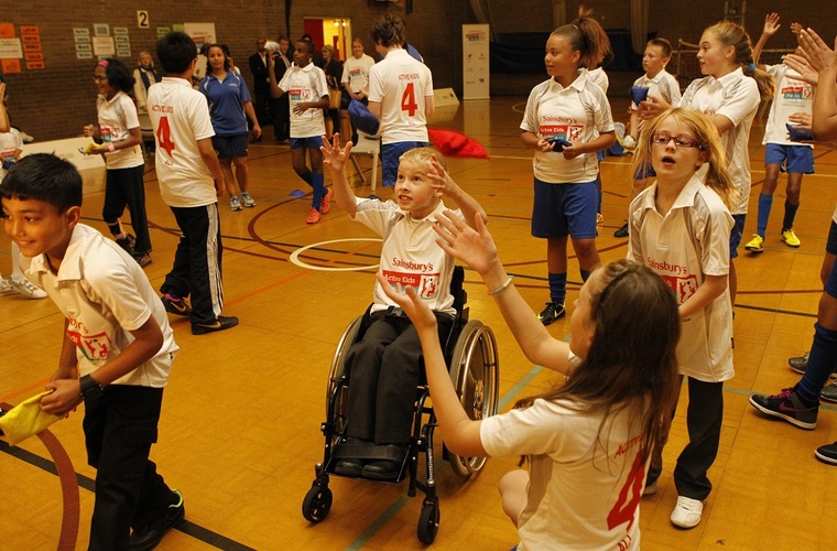 Boy in a wheelchair enjoying a PE session