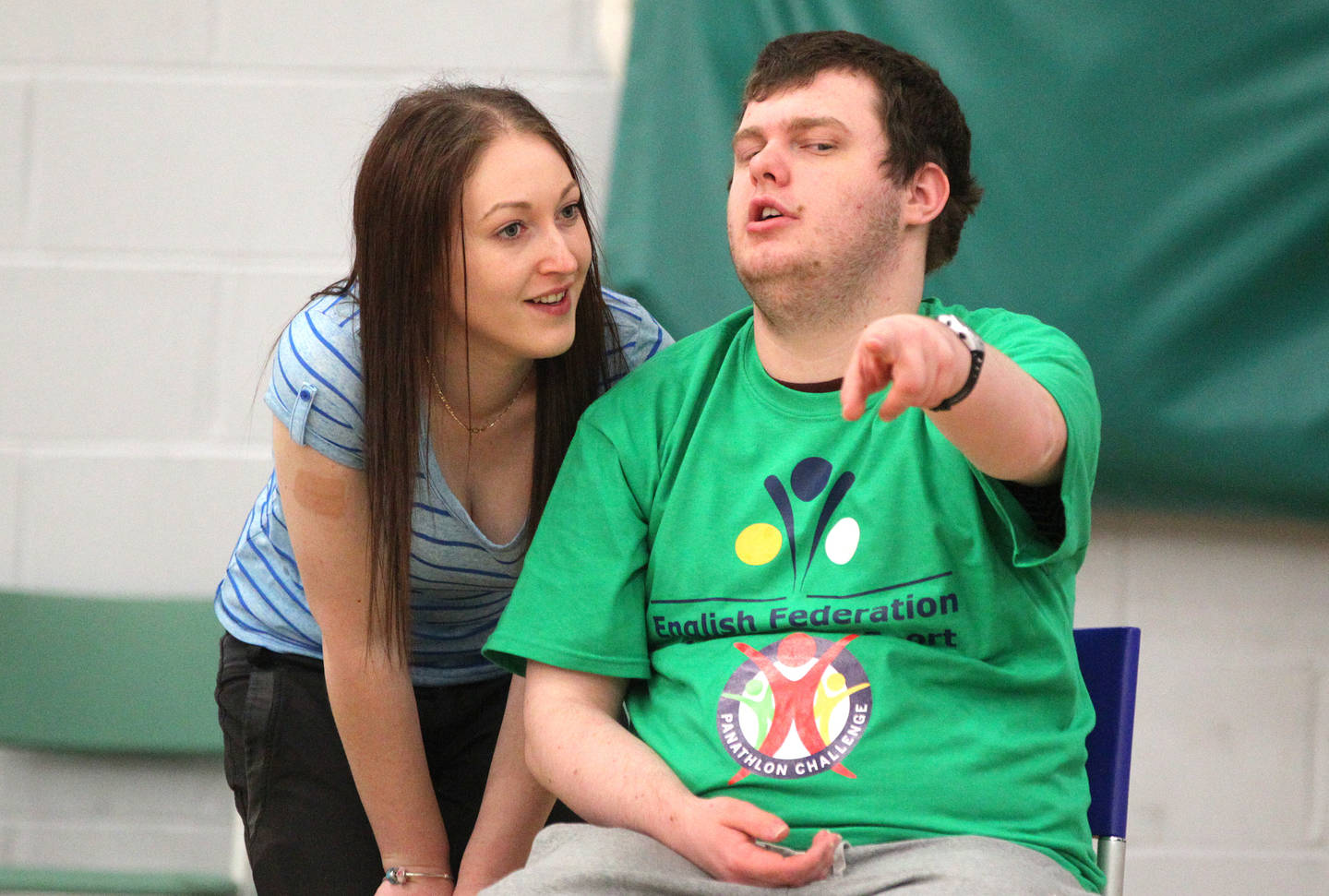 Supporter talking to a disabled child