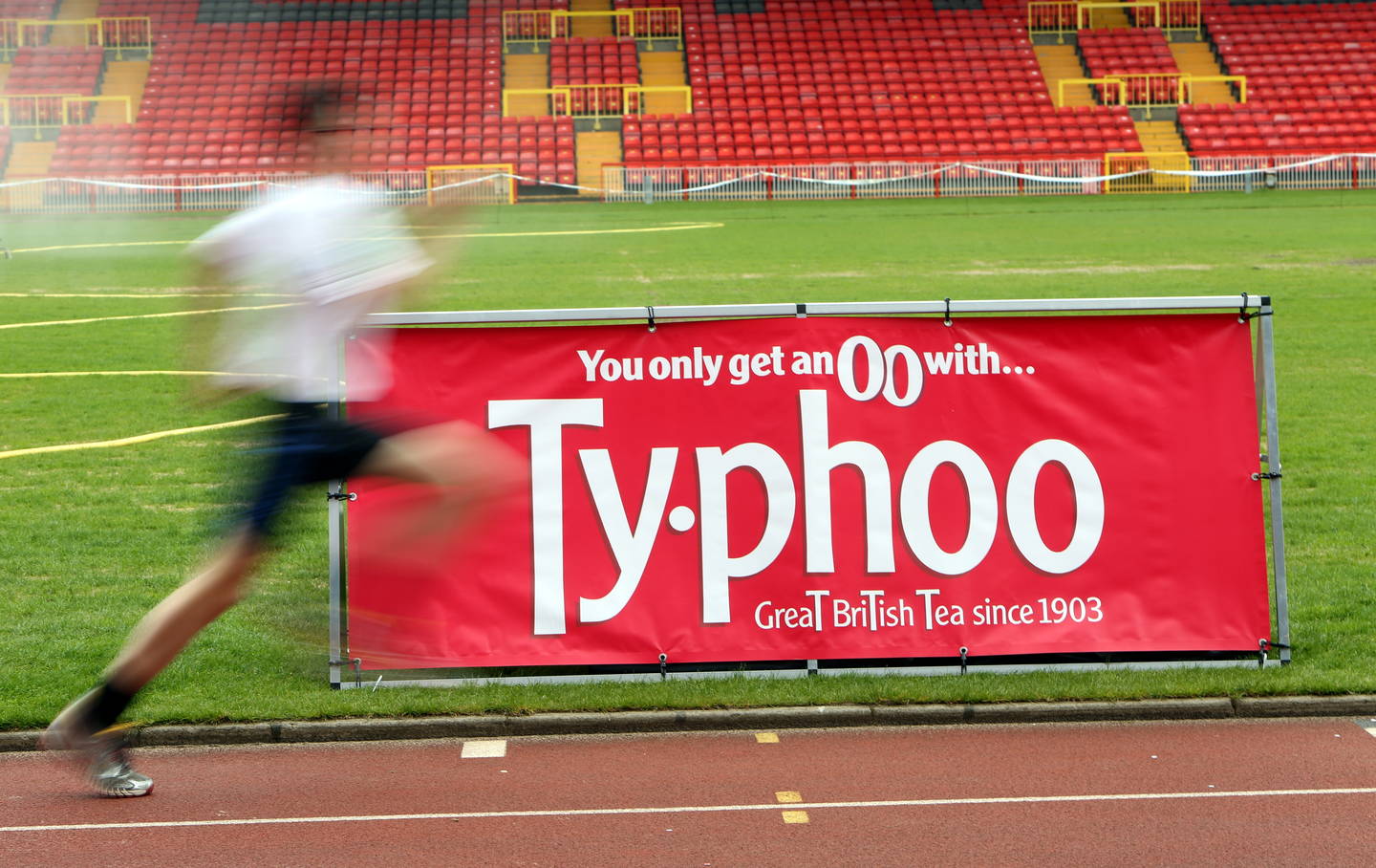 Boy running with Typhoo branding on the track