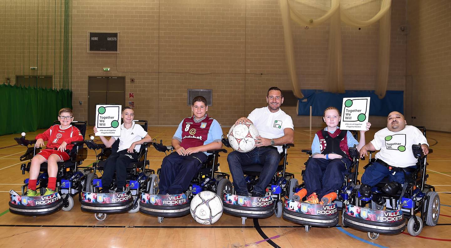 Image shows Will Mellor with Villa Rockets powerchair football players.
