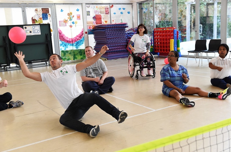 Group of people playing sitting volleyball at the London event for Together We Will
