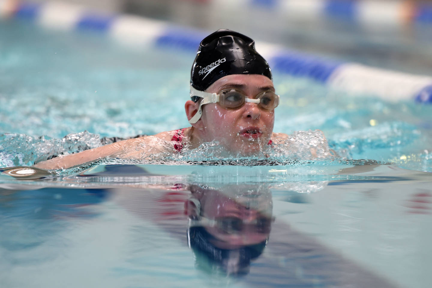 Young woman with visual impairment swimming