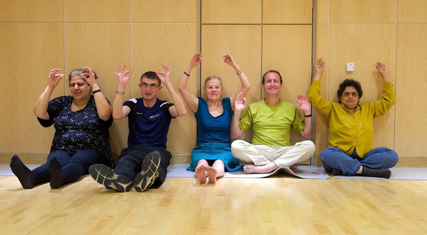 People taking part in yoga activity 