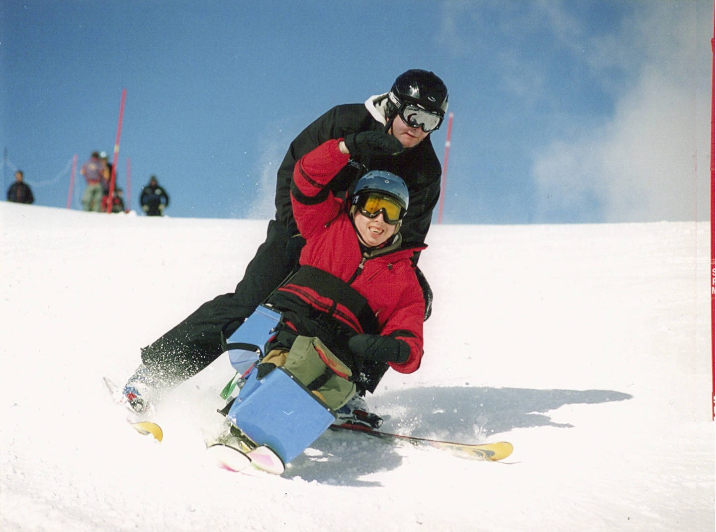 Disabled person skiing using sit-ski equipment