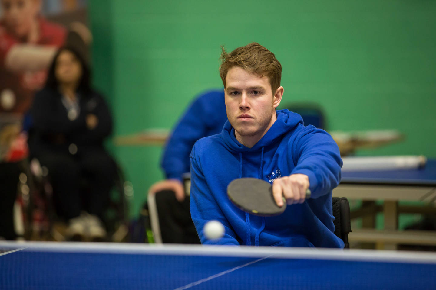 Male wheelchair user playing table tennis