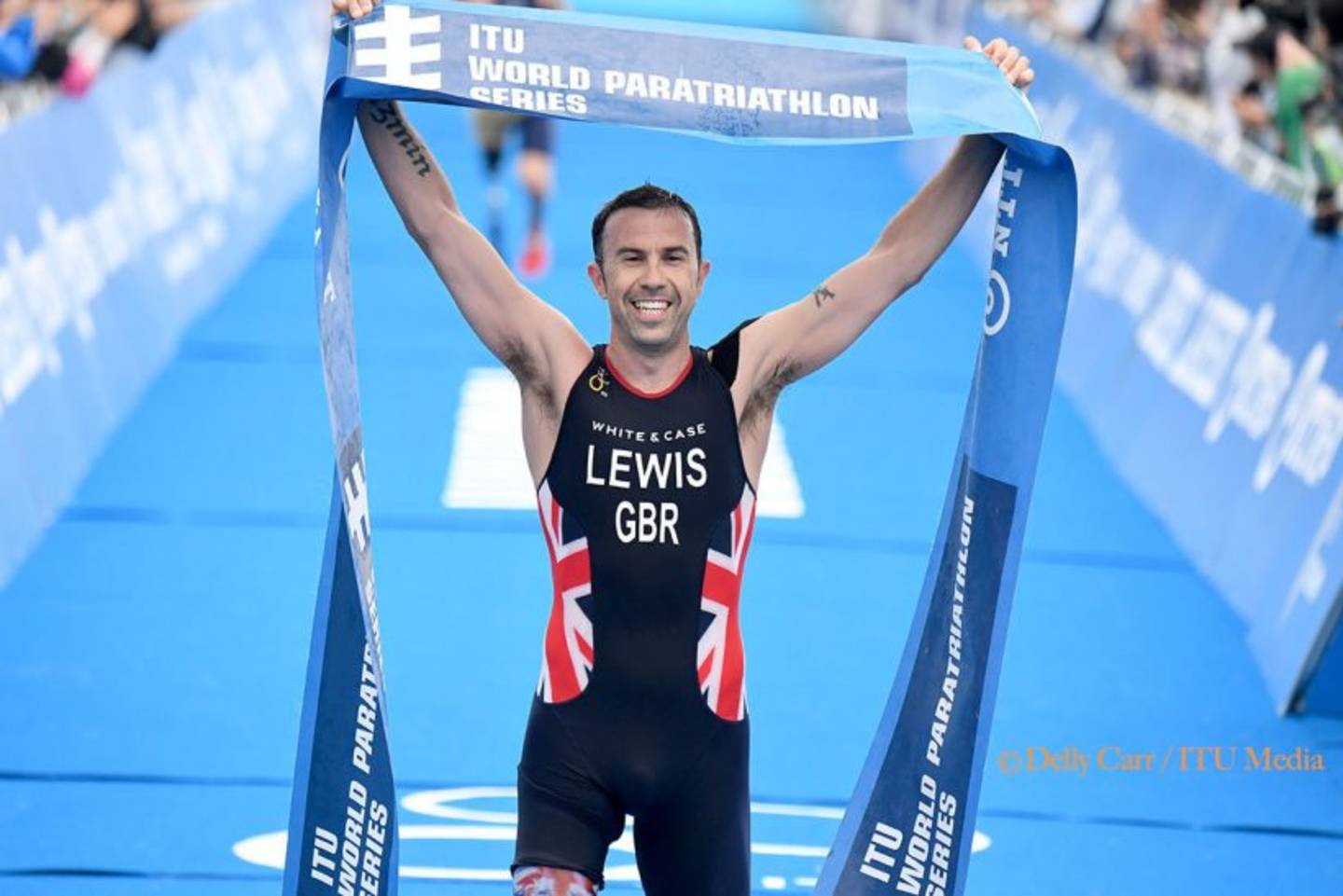 Paratriathlete Andy Lewis crossing finish line in Yokohama