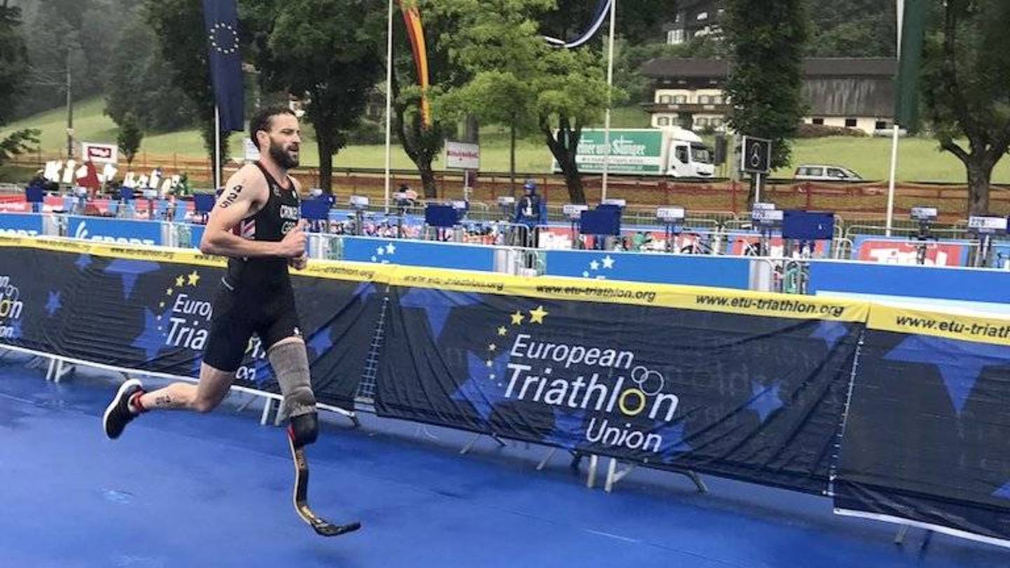 Paratriathlete Steve Crowley crossing finish line