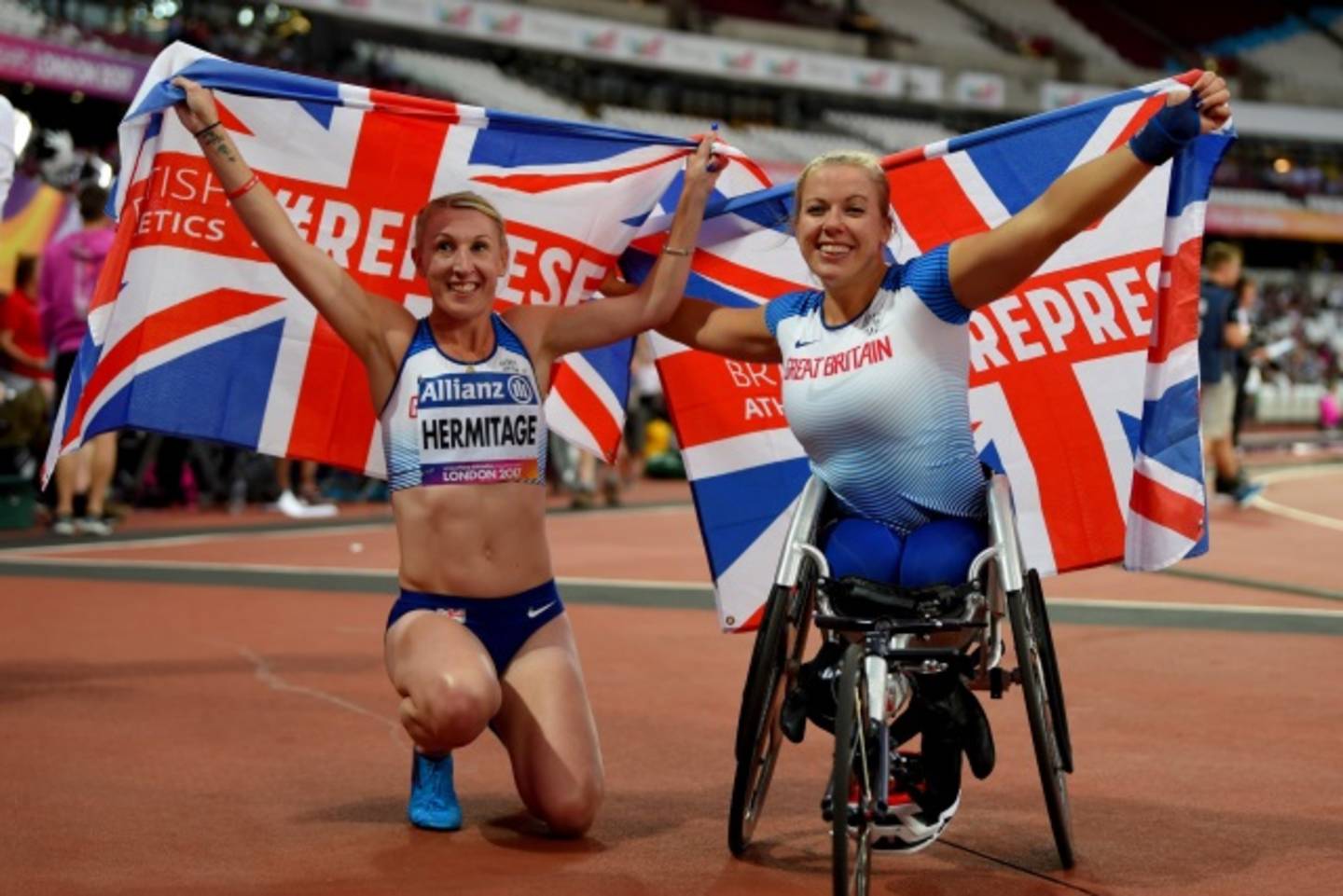 Georgina Hermitage and Hannah Cockroft holding GB flags to celebrate medal wins