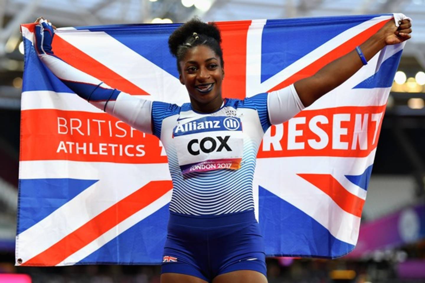 Sprinter Kadeena Cox holding Union Jack flag celebrating gold medal at World Para Athletics Championships