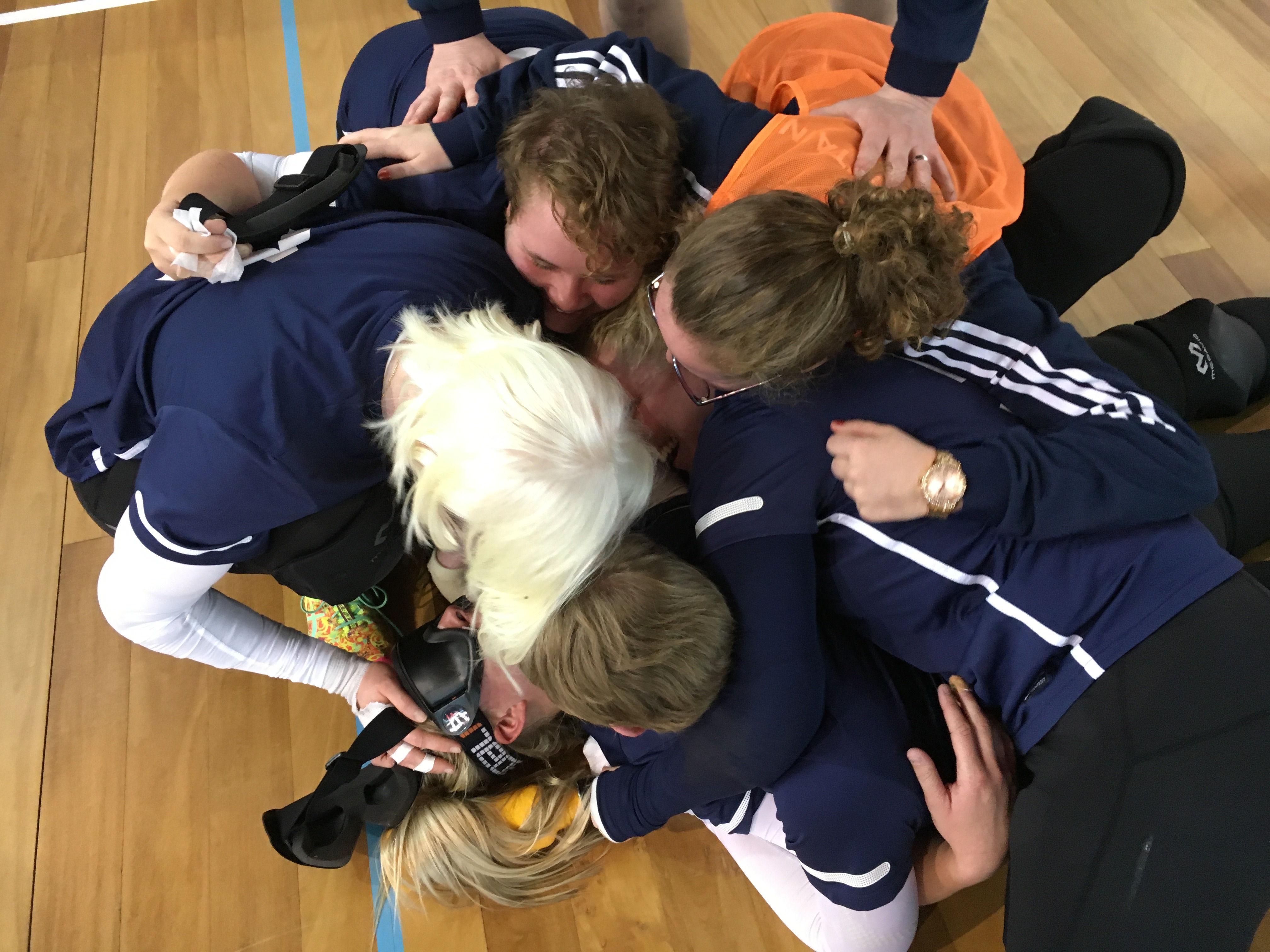 Laura Perry surrounded by her teammates after scoring a goal