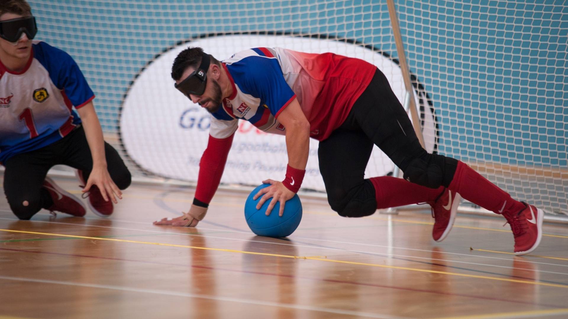 Dan Roper possessing the ball on a goalball court