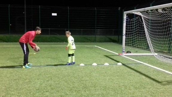 Ben Meadows teaching a young player to dribble through cones