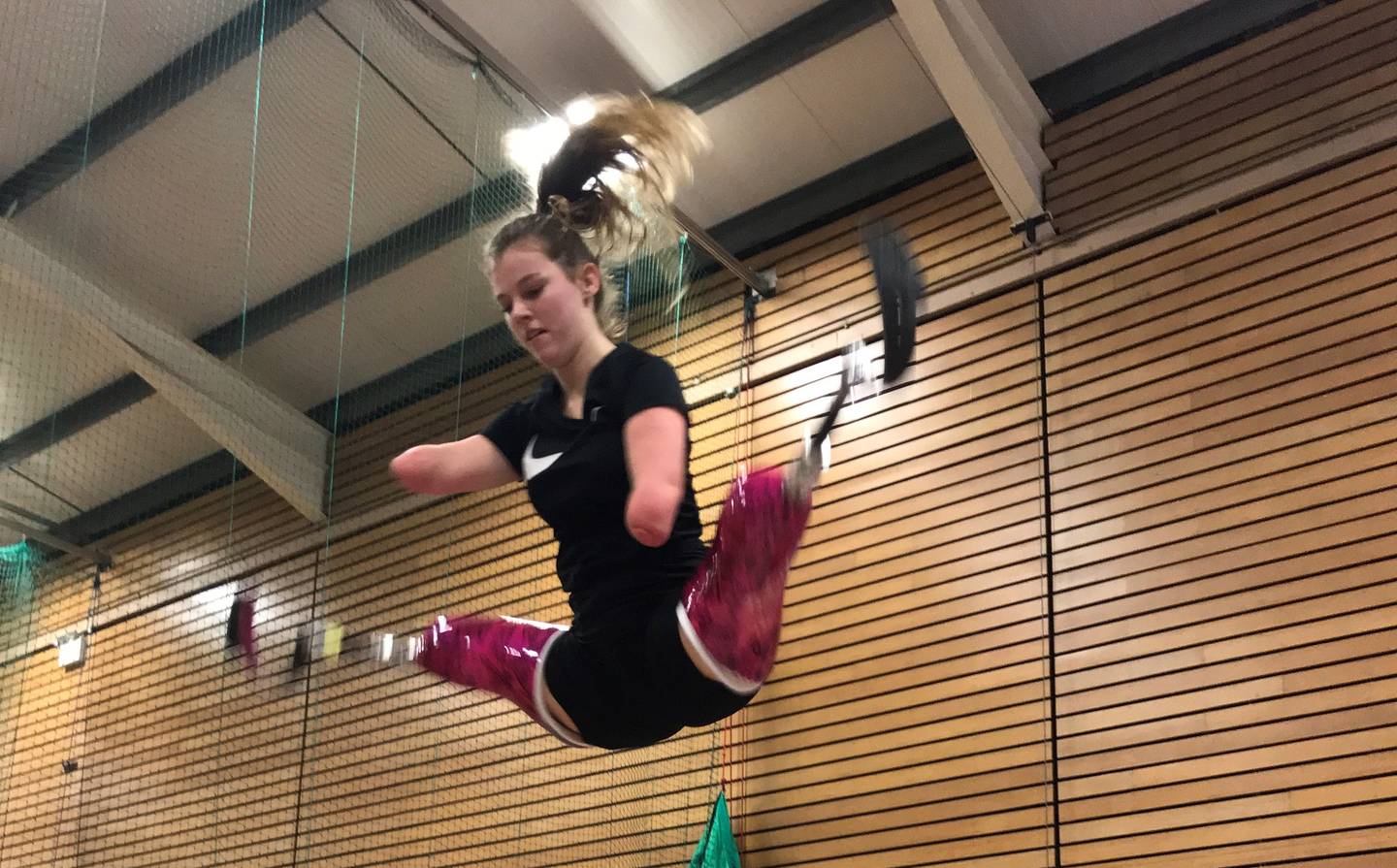 Isabelle doing a starjump on the trampoline. 