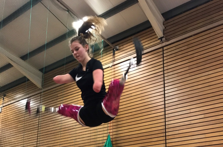 Isabelle doing a starjump on the trampoline. 