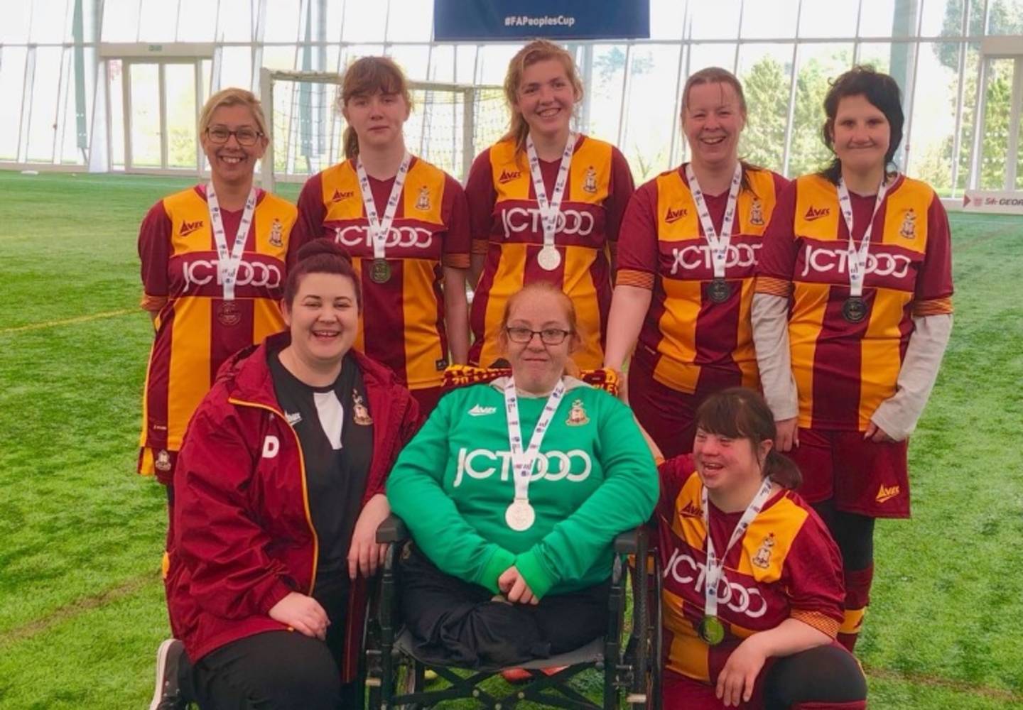 Team photo of Bradford City Disability Ladies FC with their runners up medals