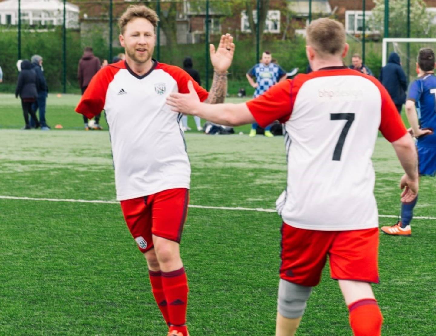 Jason and teammate celebrating during football match