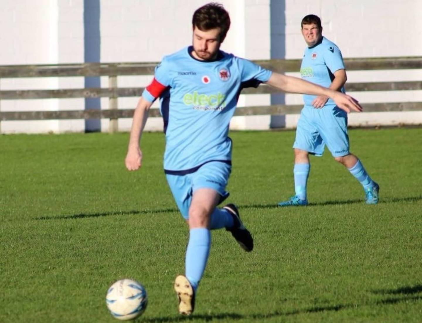 Thomas striking the football during a match for Carlisle City Deaf FC