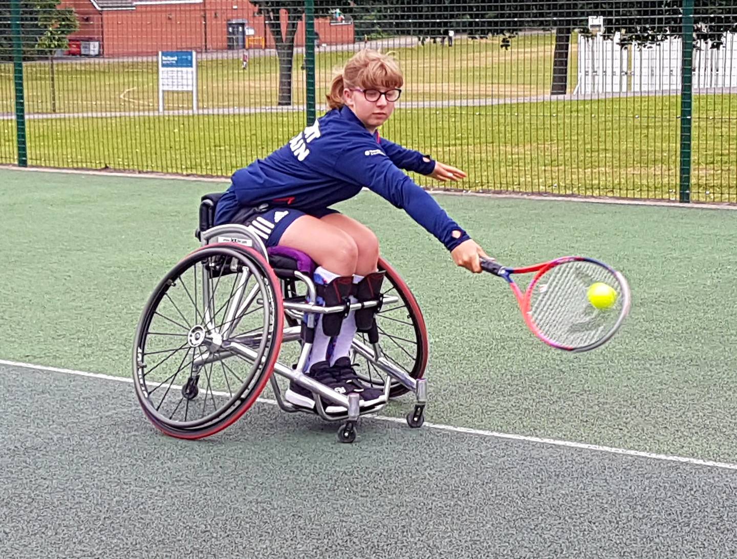 Abbie playing wheelchair tennis 