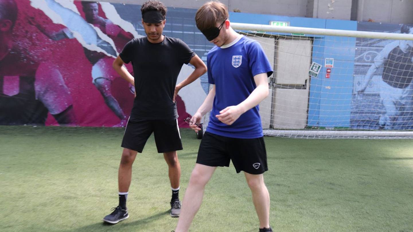 Two boys playing blind football