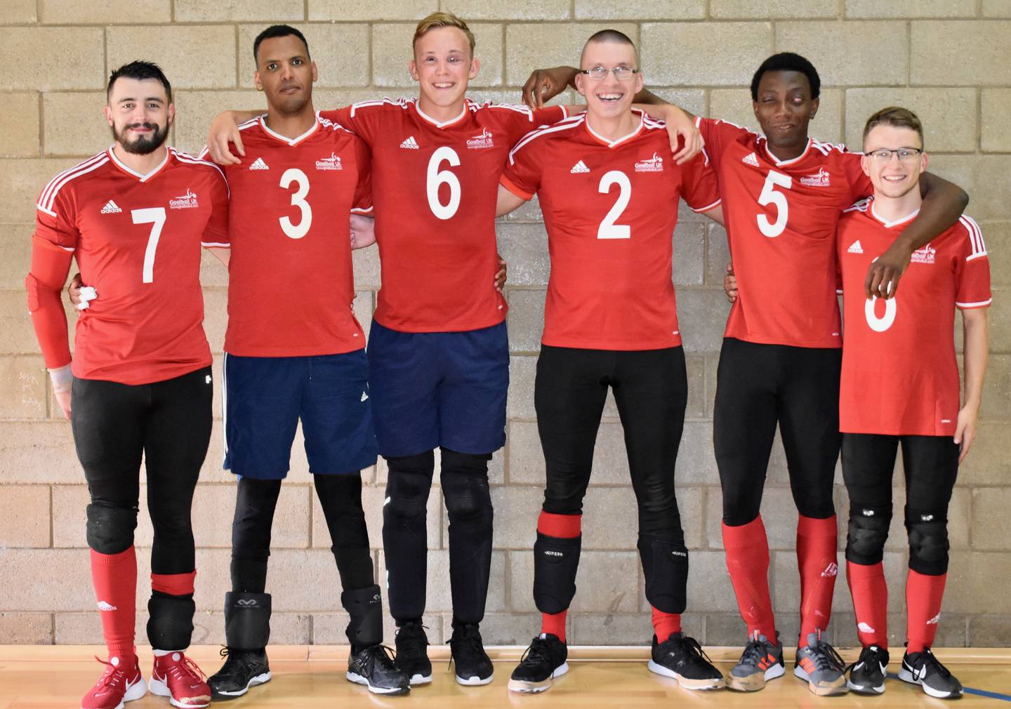 Photo of GB men's goalball squad left to right Dan Roper, Filmon Eyassu, Josh McEntee, Matt Loftus, Caleb Nanevie, Joe Roper