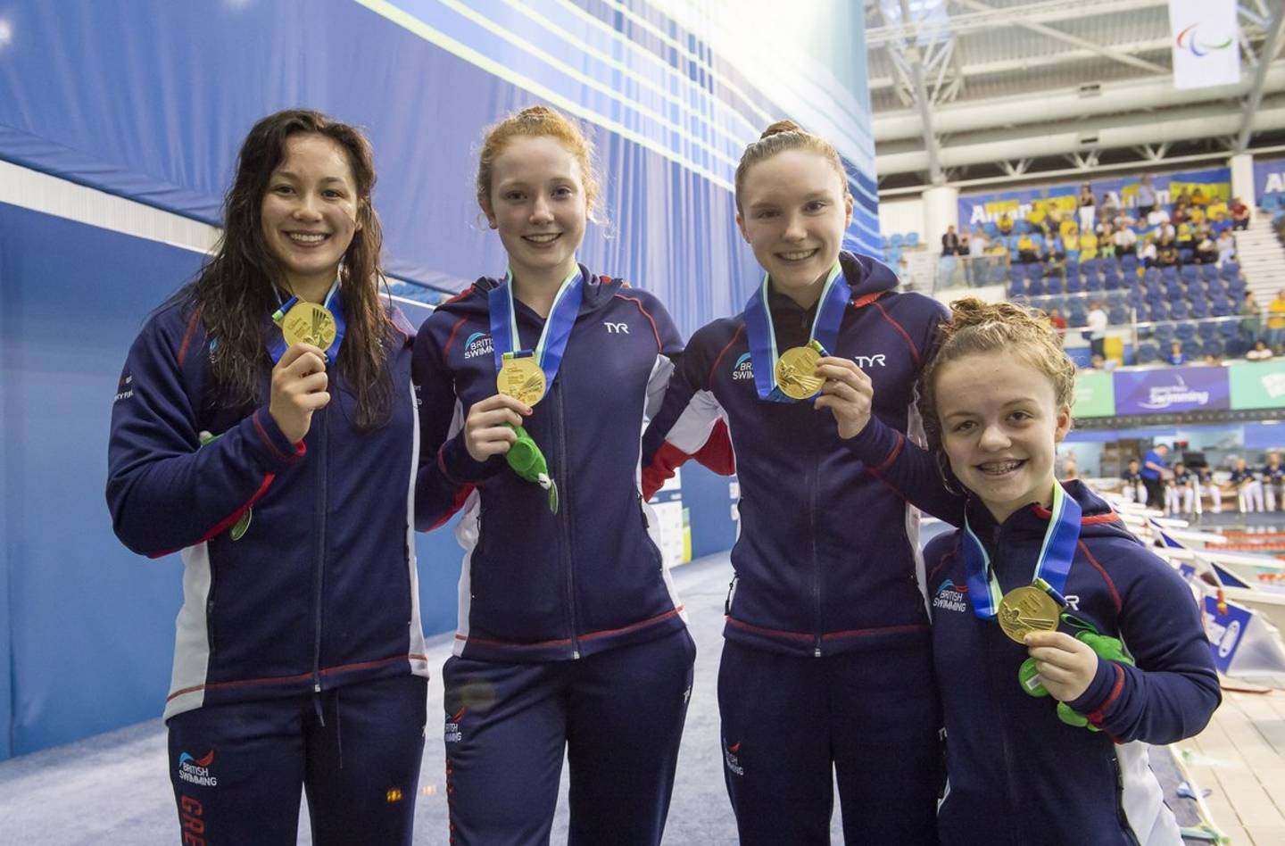 The women's relay team celebrate with their gold medal