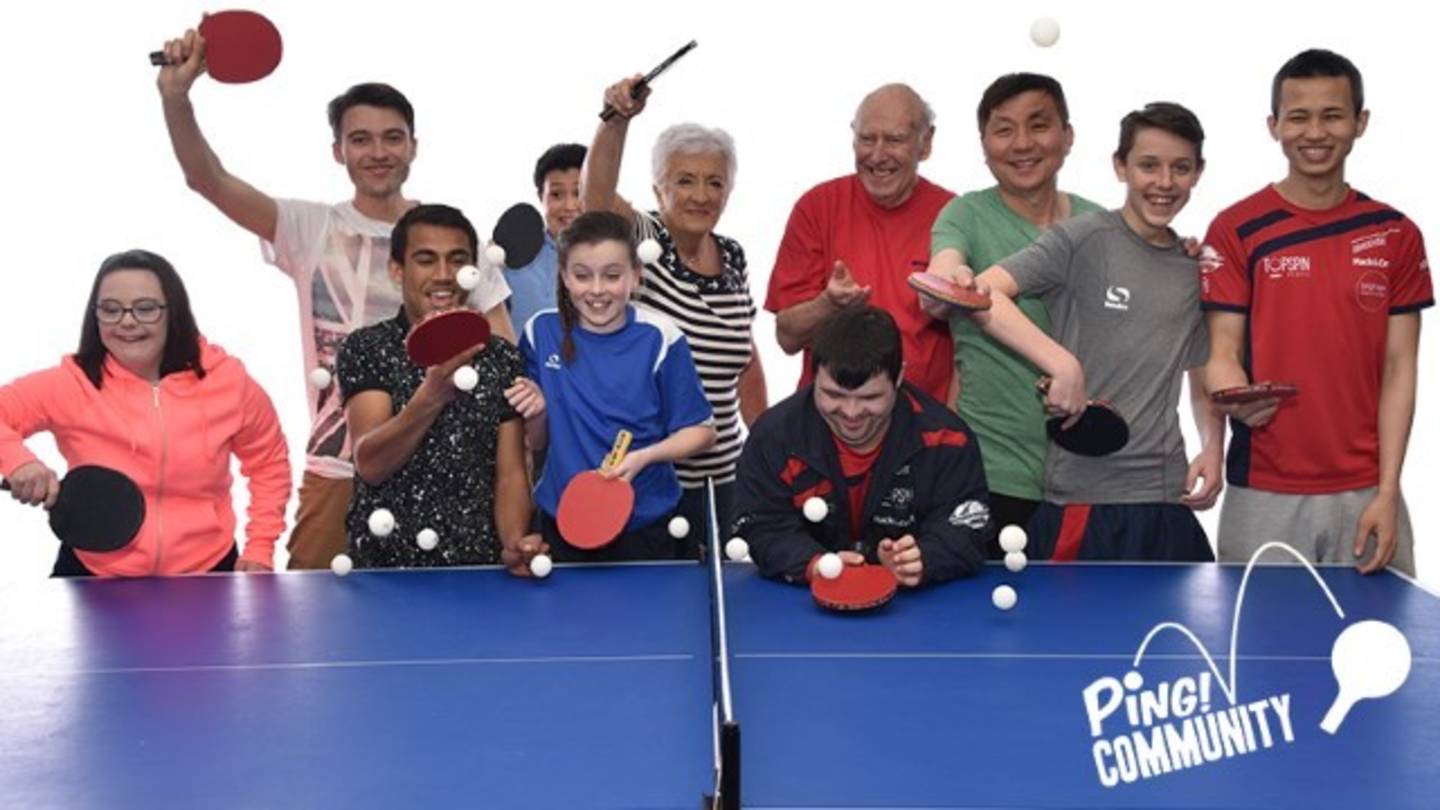 People of different ages and backgrounds smiling ready to play table tennis