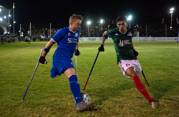 Martin playing on crutches for England in World Amputee Football Cup.