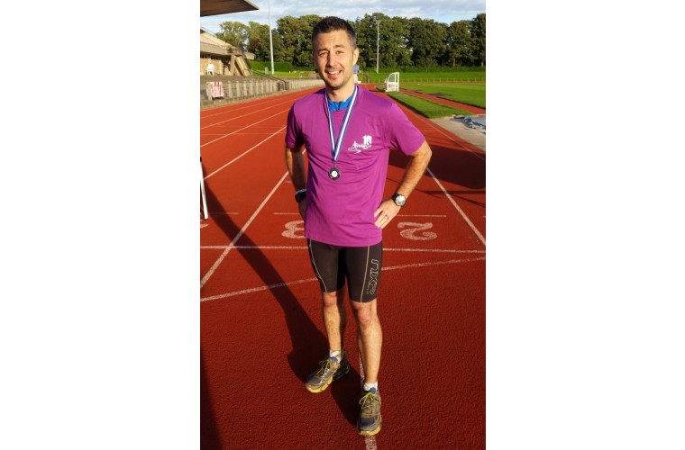 Craig with medal after finishing a 40 mile ultra run event