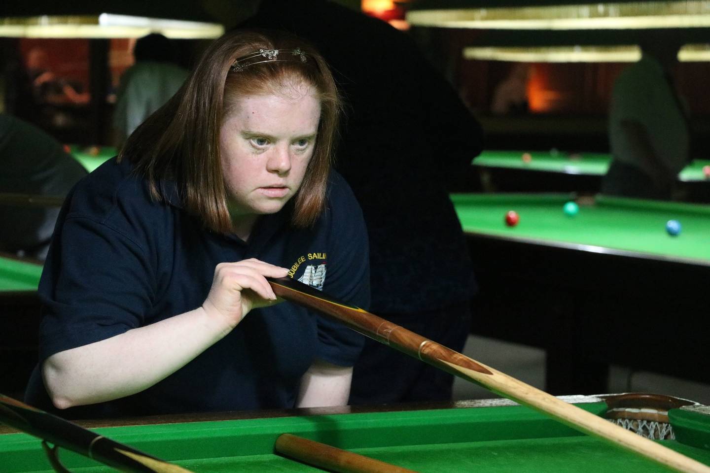 Female playing snooker. 