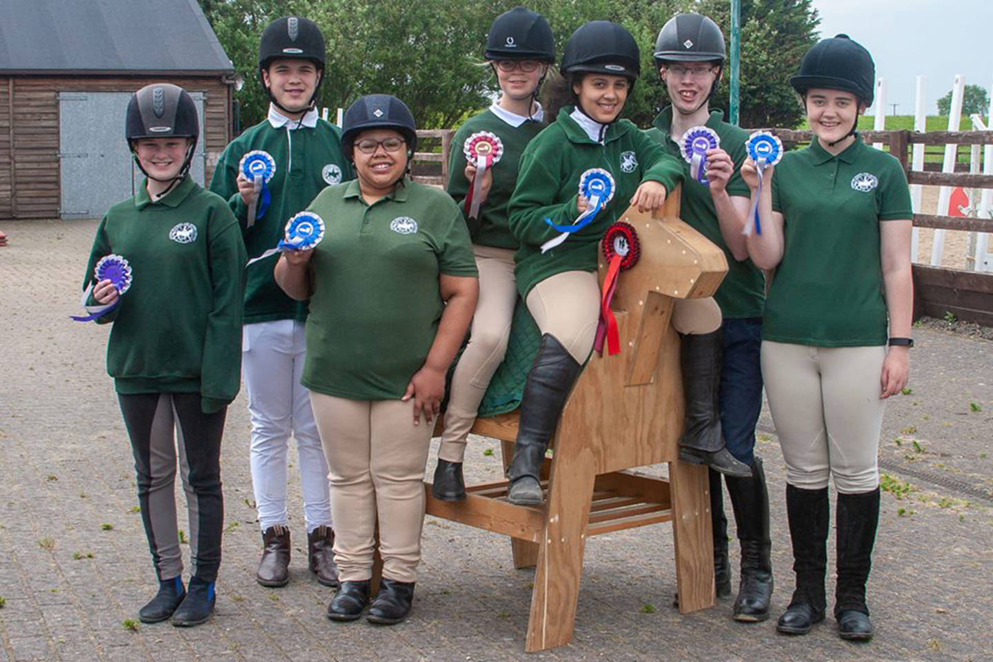 Phoebe sat at the front on a wooden horse with friends at Scropton RDA group