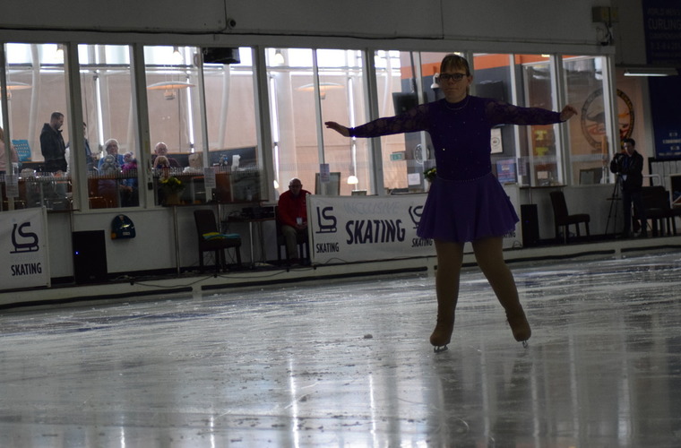Vicki figure skating on the ice. 