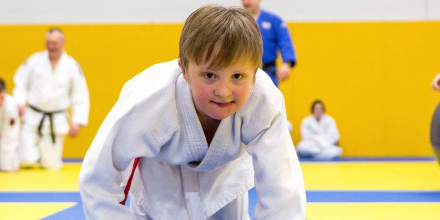 Young boy on smiling to camera in judo gear. 