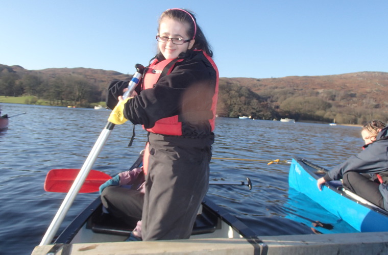 Sophie kayaking smiling to camera. 