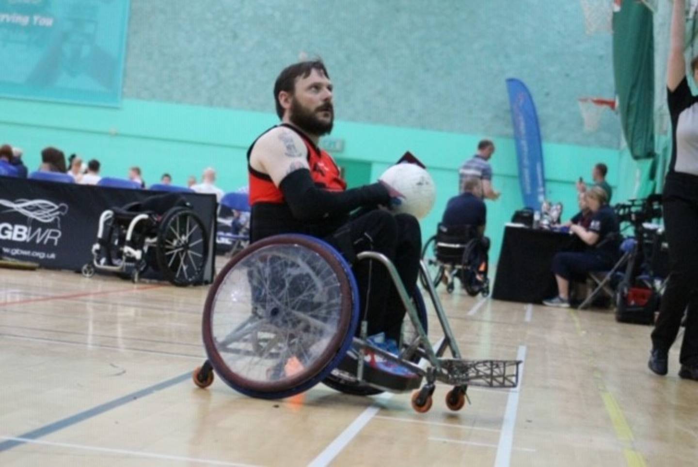 Ryan on court with rugby ball in hand. 