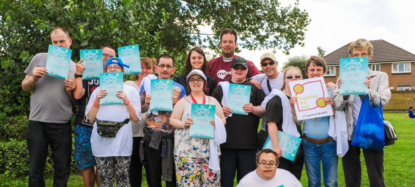 People with learning disability holding their Round the world challenge certificates