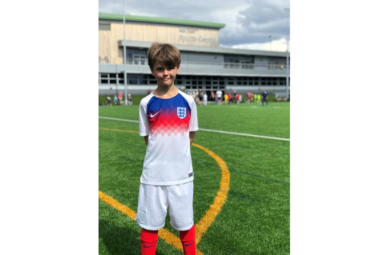 Bryan smiling to camera in his CP England football kit 