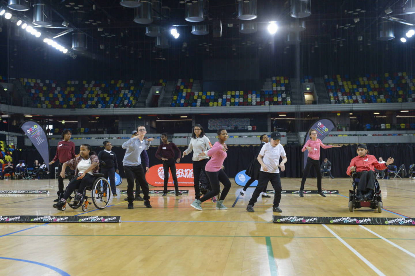 A range of dancers in a sports hall. 