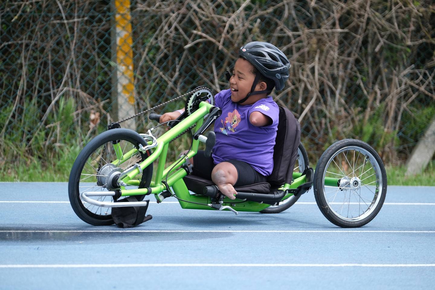 Boy cycling using a hand bike at LimbPower Junior Games