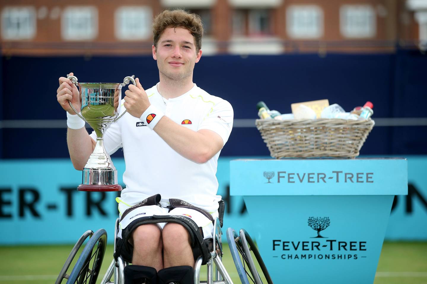 Alfie Hewett holding winner's trophy at Fever-Tree Championships Winner. Photo credit: LTA