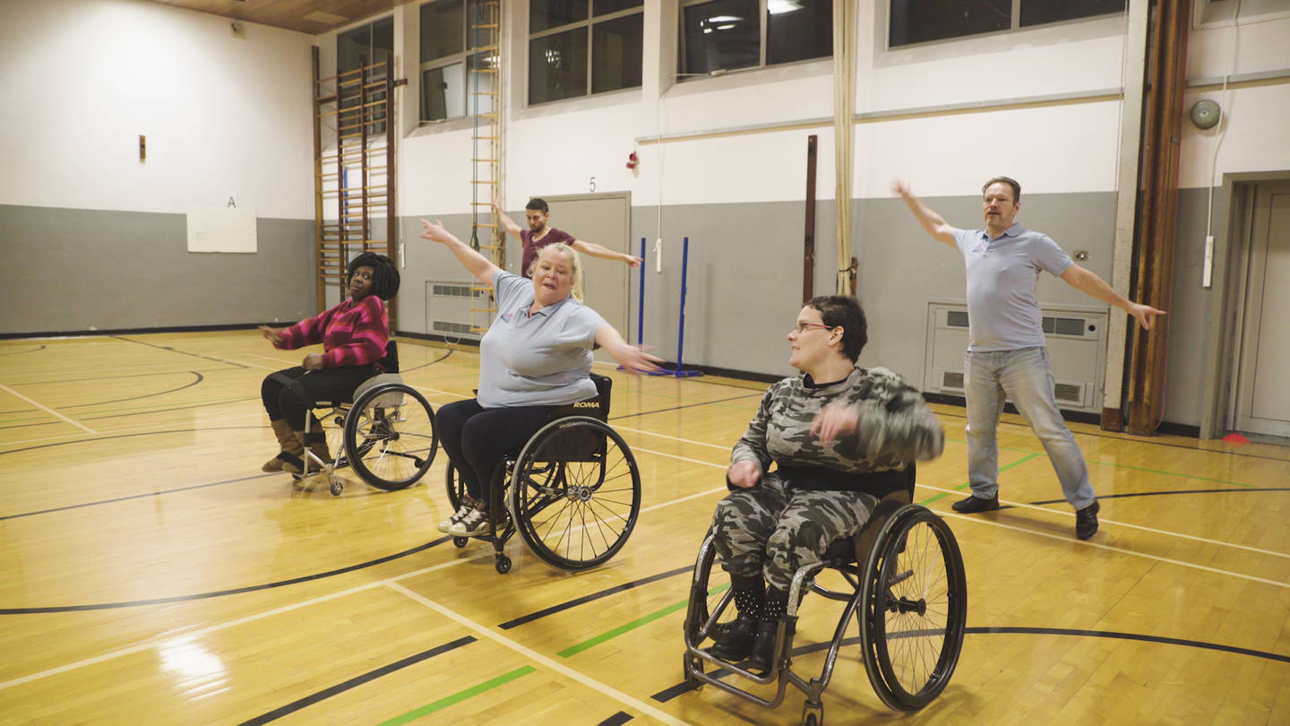 Wheelchair users and non-disabled people dancing 