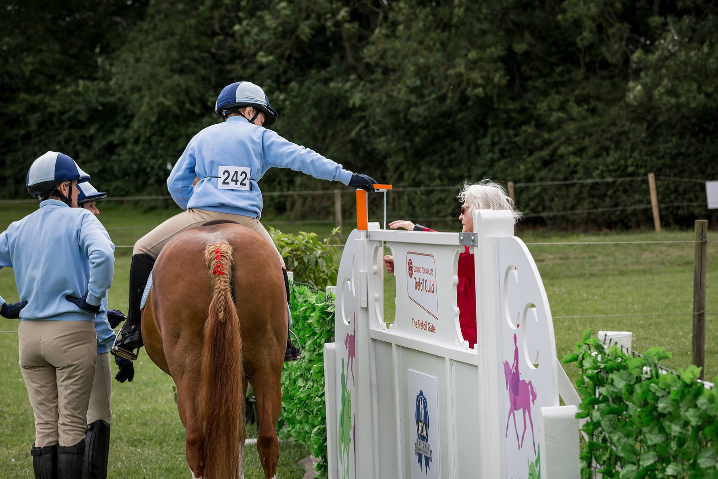 Disabled rider on horse checking height of the jump on course
