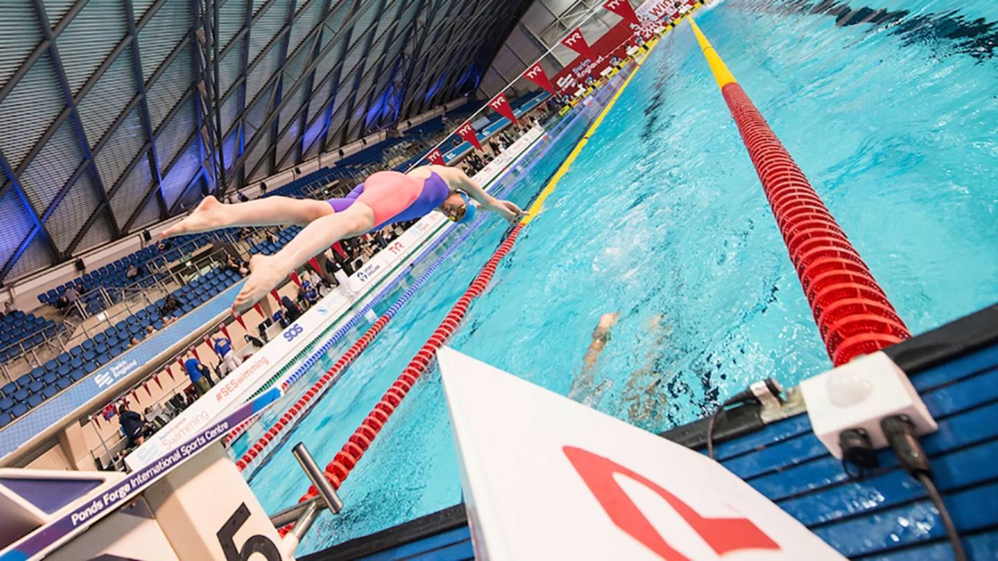 Swimmer diving into swimming lane