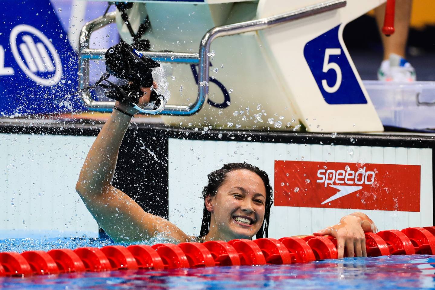 Alice Tai celebrating after winning race in swimming pool