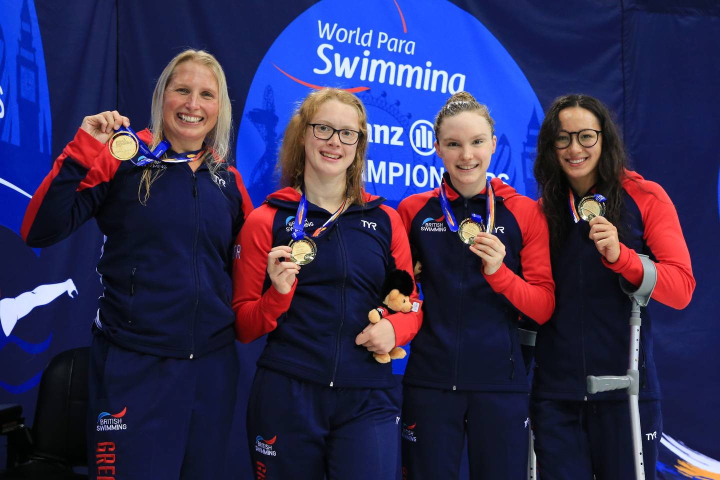 Women’s 34pt 4x100m Freestyle Relay team with gold medals in hand.
