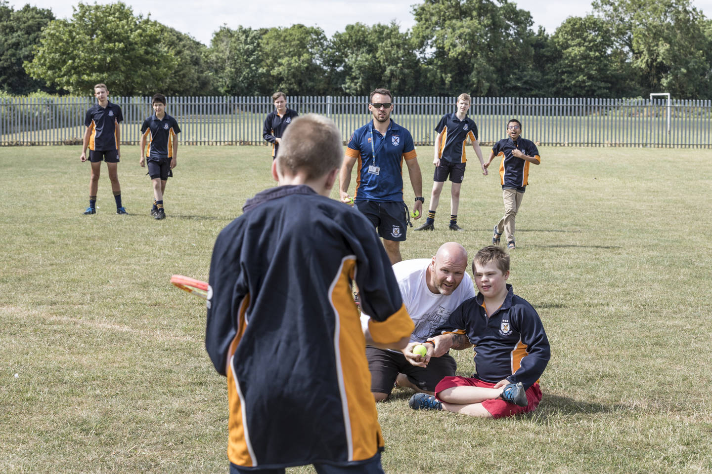 Teacher delivering inclusive rounders session outside on school field