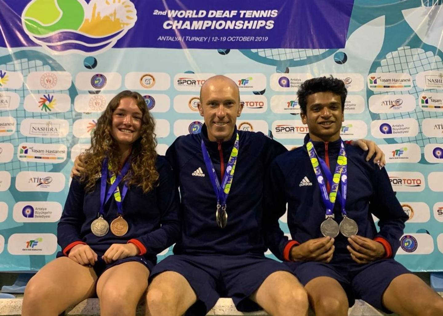 Lewis Fletcher, Phoebe Suthers and Esah Hayat wearing their World Deaf Tennis Championships medals
