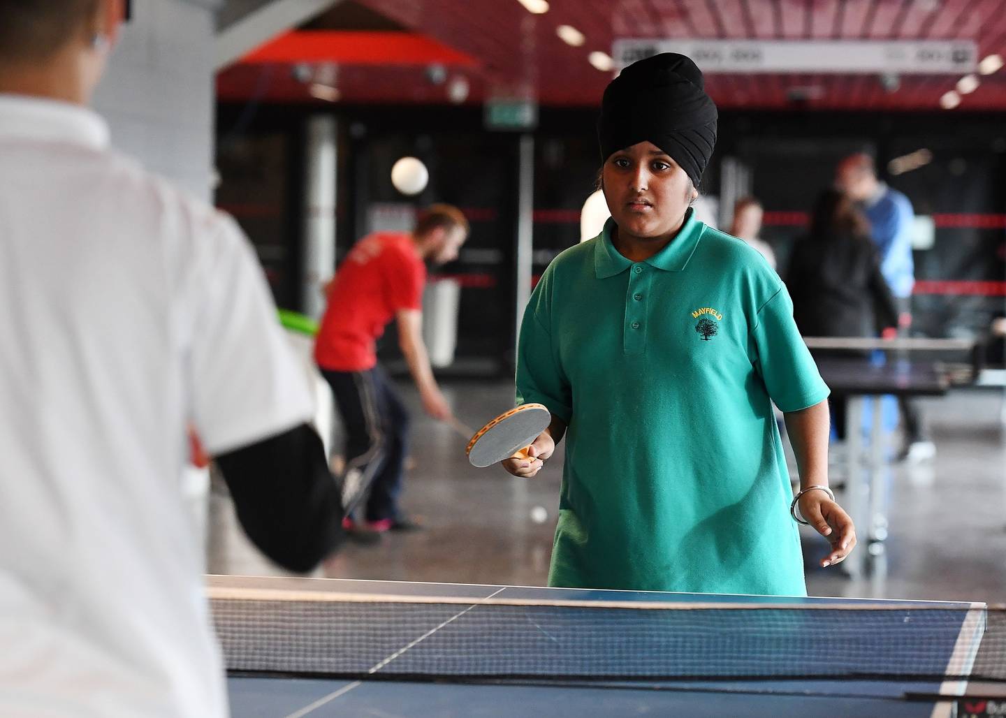 Boy plays table tennis at school event