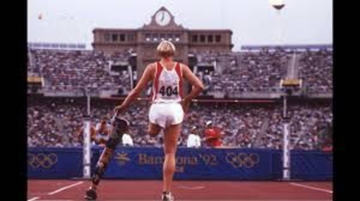 Sporting Hertiage image of Barcelona 1992 Paralympics showing highjumper stadnign in front of crowd. 