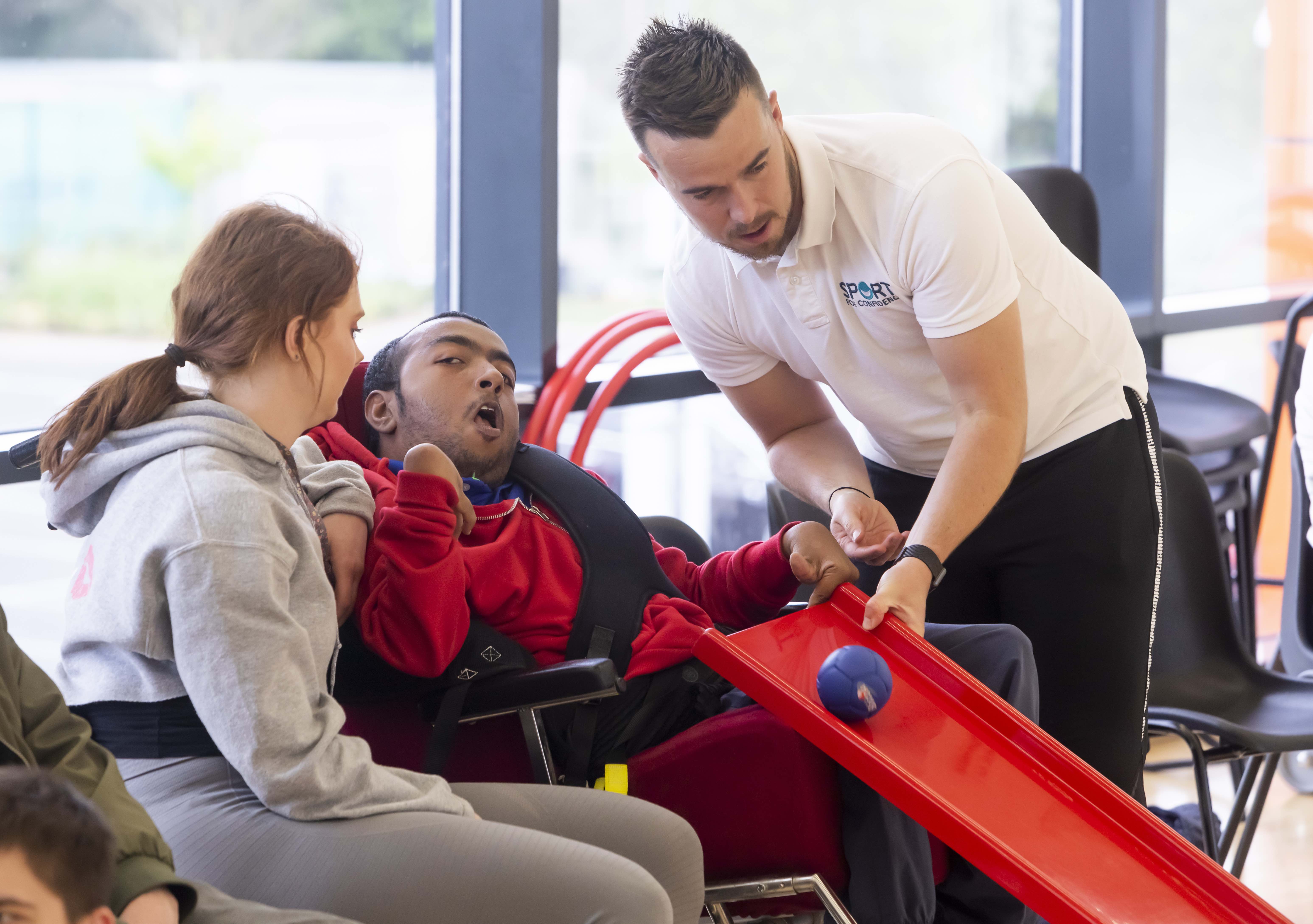 Sport for Confidence client session shows occupational therapist supporting a disabled man with Boccia.